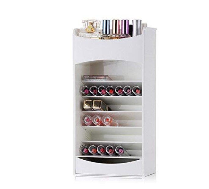 White cosmetic storage rack with slanted shelves of lipsticks and a bottom drawer