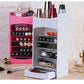 Pink and white cosmetic storage racks holding lipsticks, perfume and makeup brushes